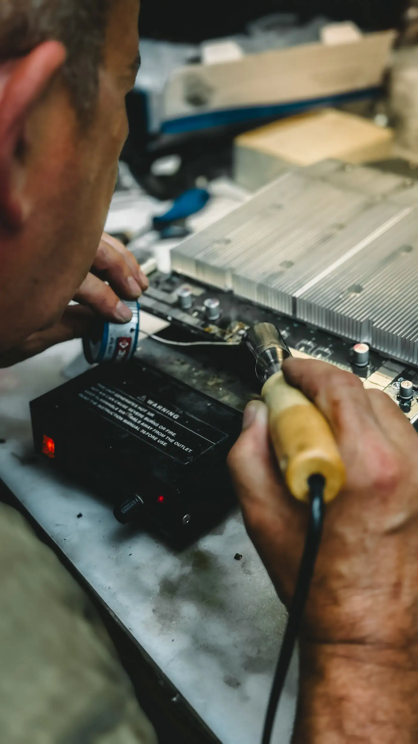A qualified artisan working with a hand tool